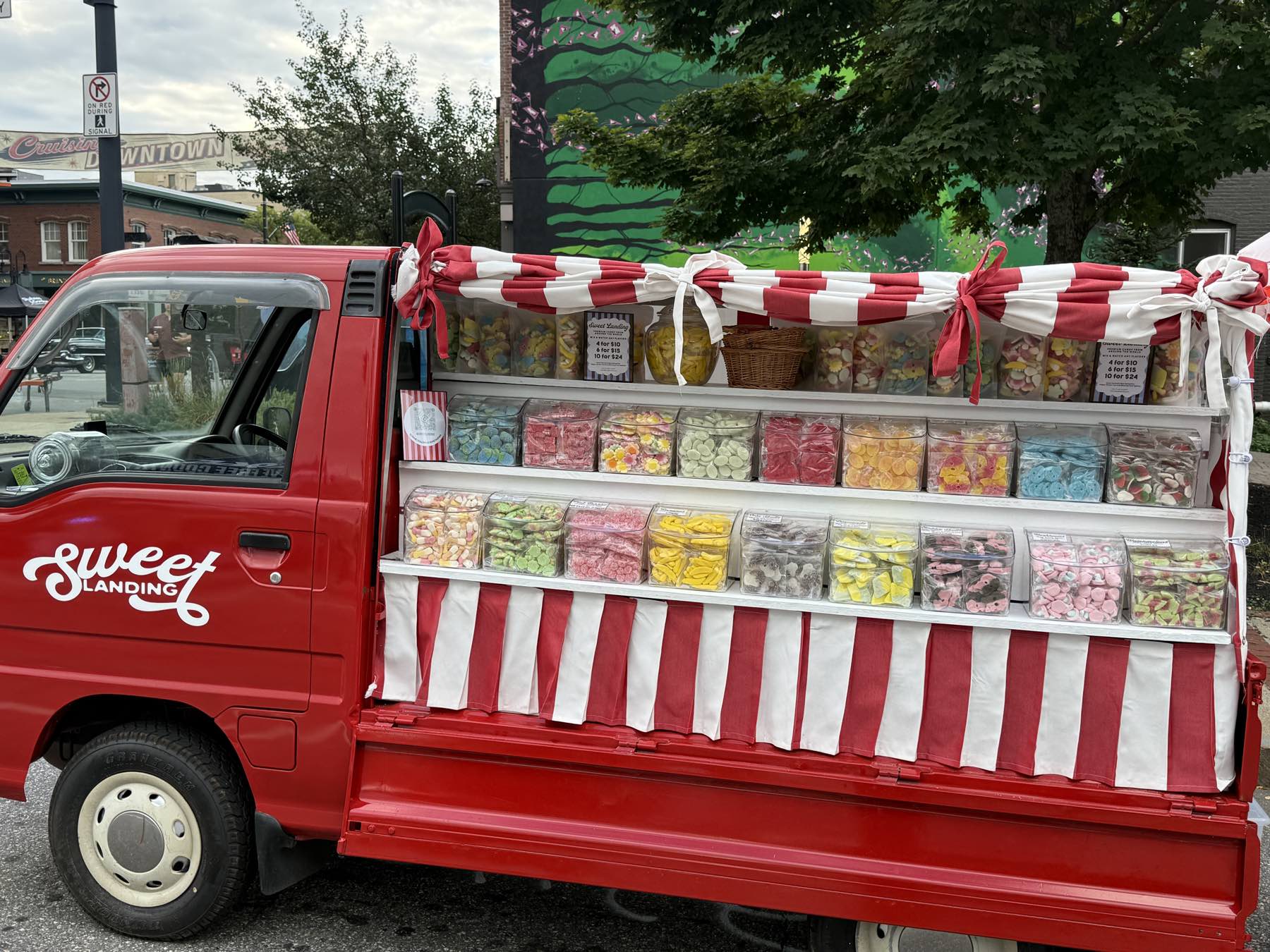 Sweetie parked downtown with her candy shelves open and the striped valance up