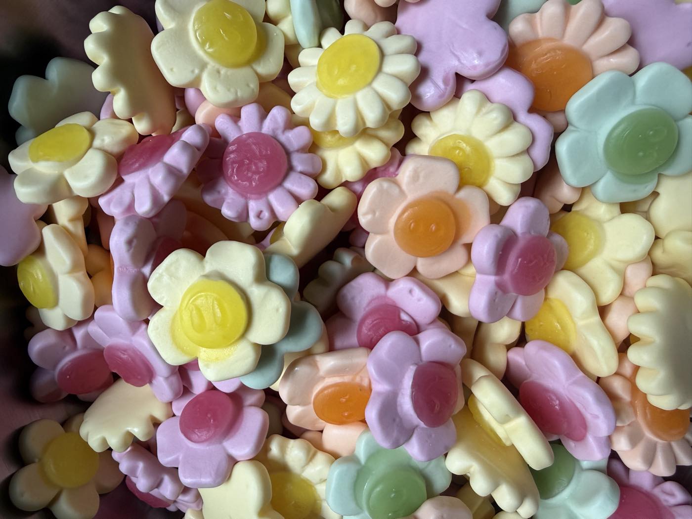 A close-up of pastel flower and daisy sweets