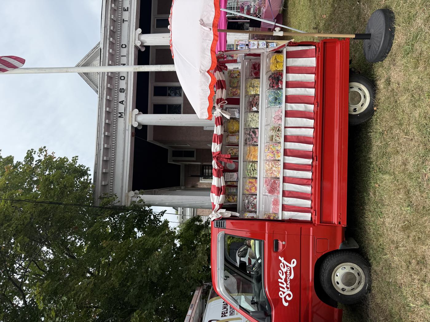Sweetie set up on the green outside the Masonic Temple, parasol up