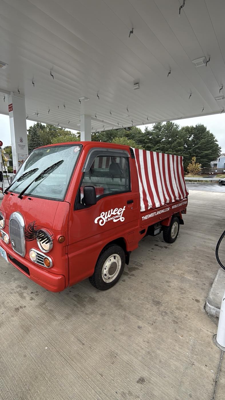 Sweetie at the petrol station, striped cover over the bed